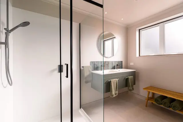 Bathroom with large glass walk-in shower and heated floor