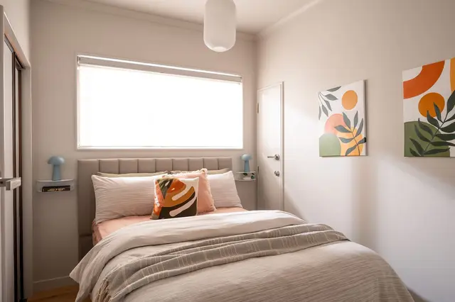 Second bedroom with double bed and colourful art