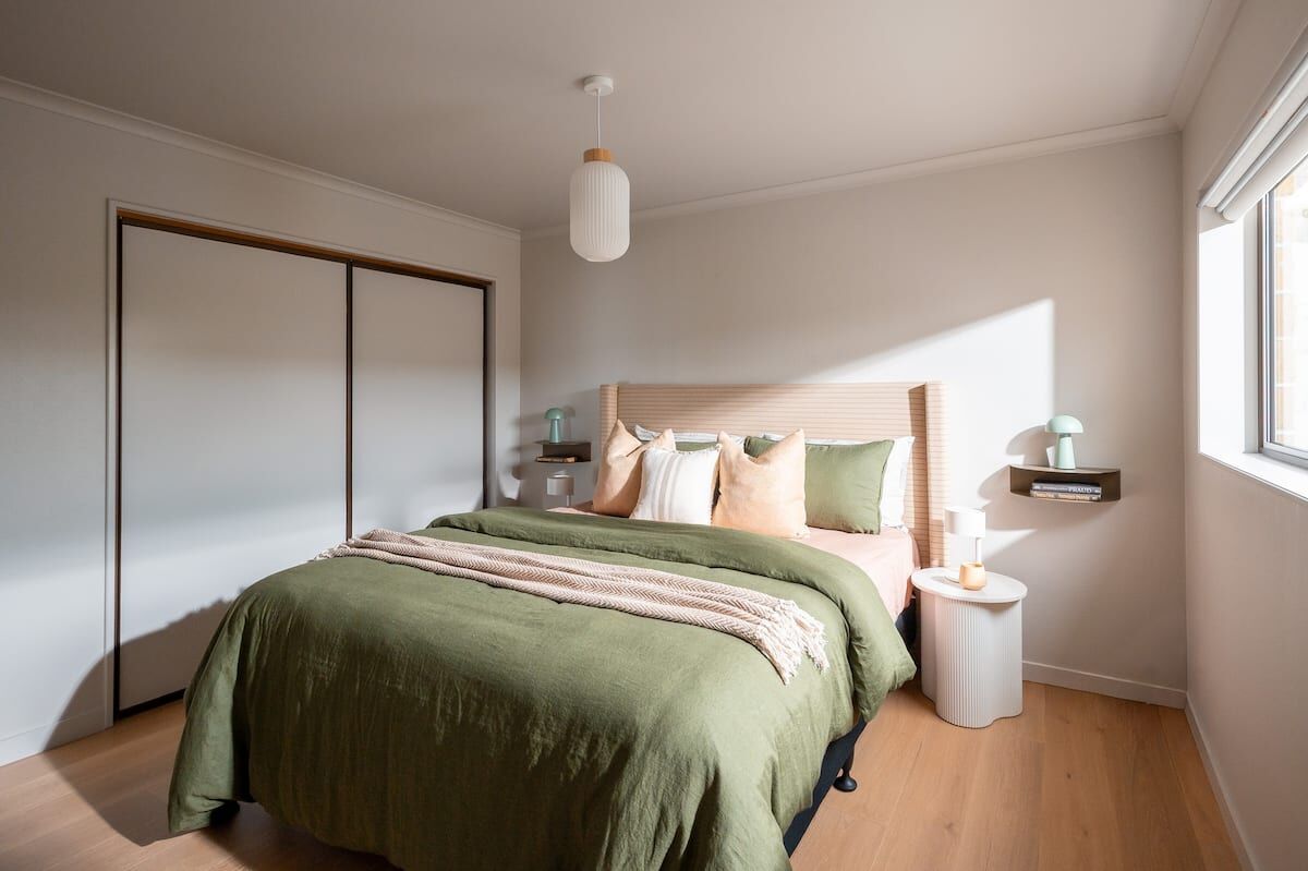 Master bedroom with king bed, sage linen and black-out blinds