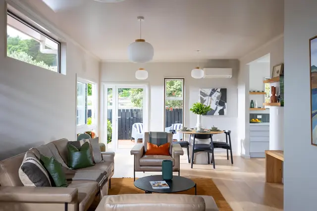 Lounge with sofas, armchair and TV opening to the garden