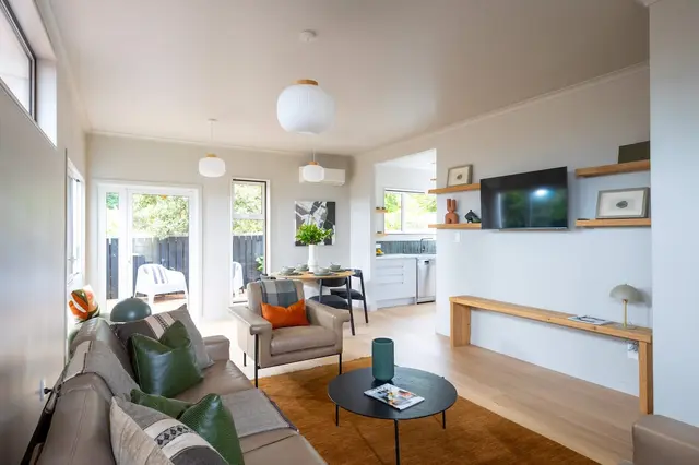 Lounge seating with cushions and wall-mounted TV